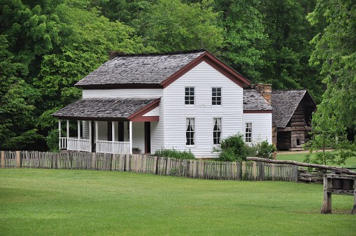 Enjoy historical sites like this Cades Cove Bus Tour house.